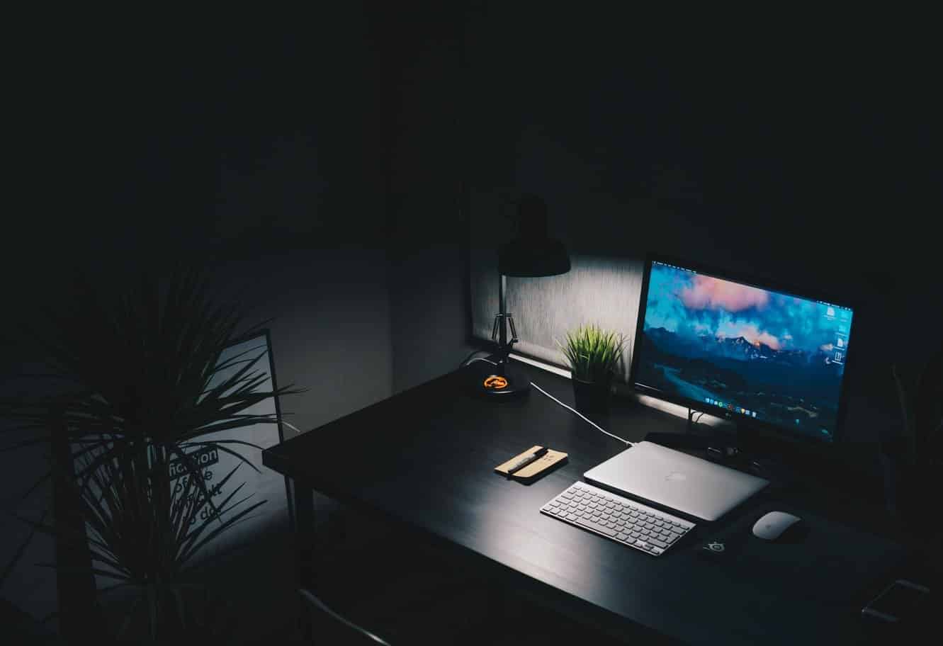 a workspace setup with a lamp on