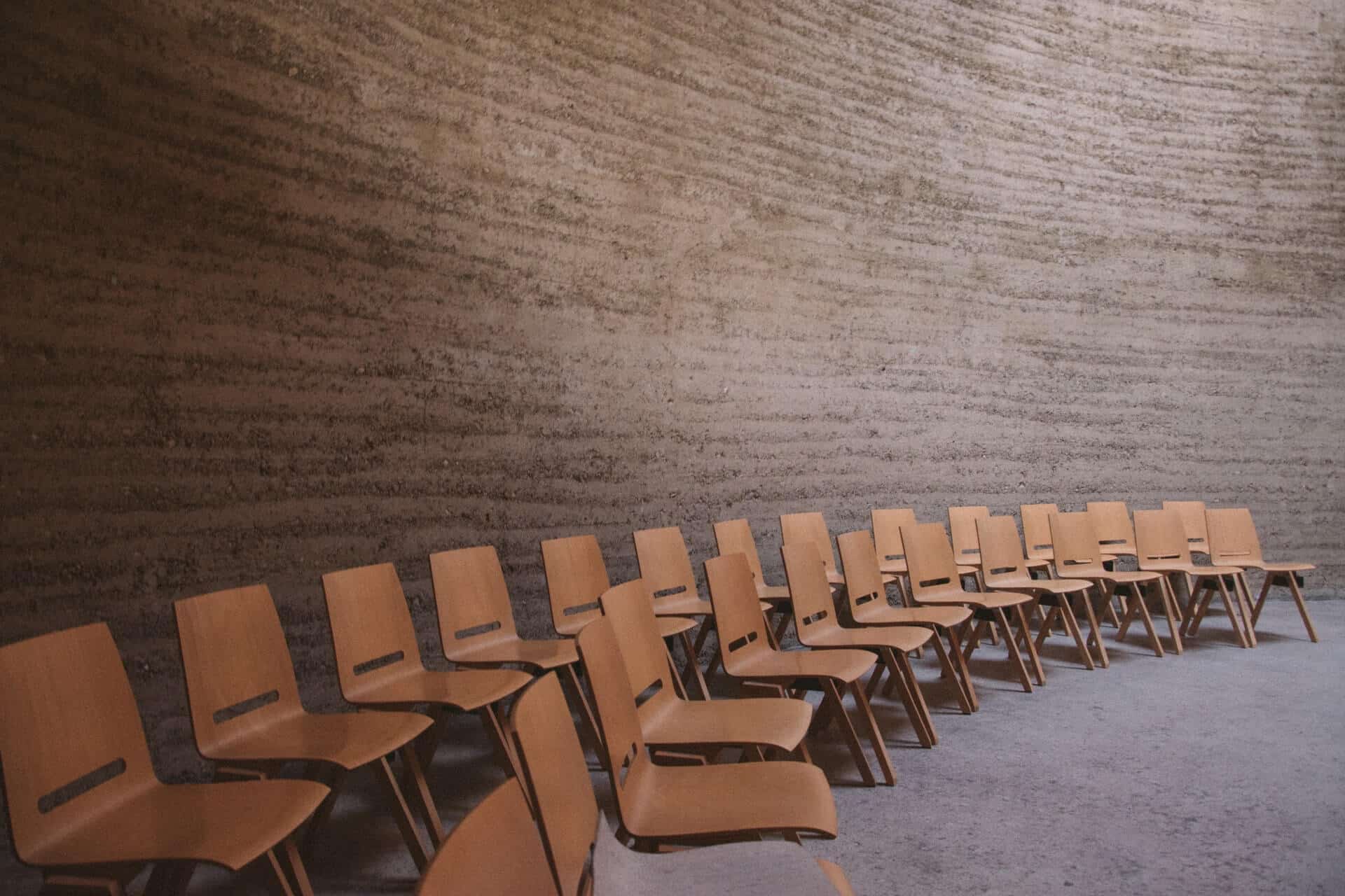 chairs arranged in a semi circle with brown walls