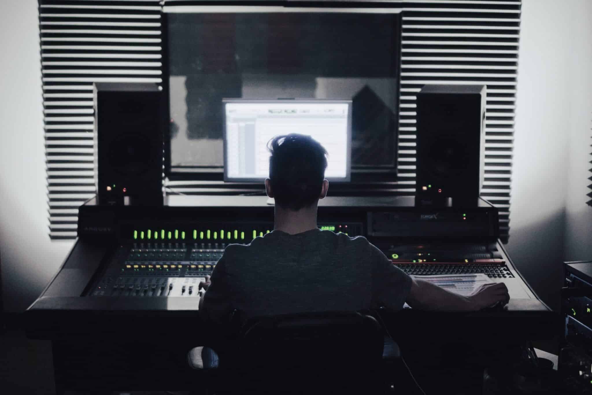 person working in front of an audio editing device