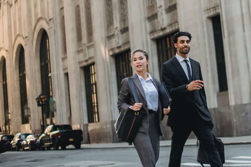 Attorneys walking on the road in a corporate attire.