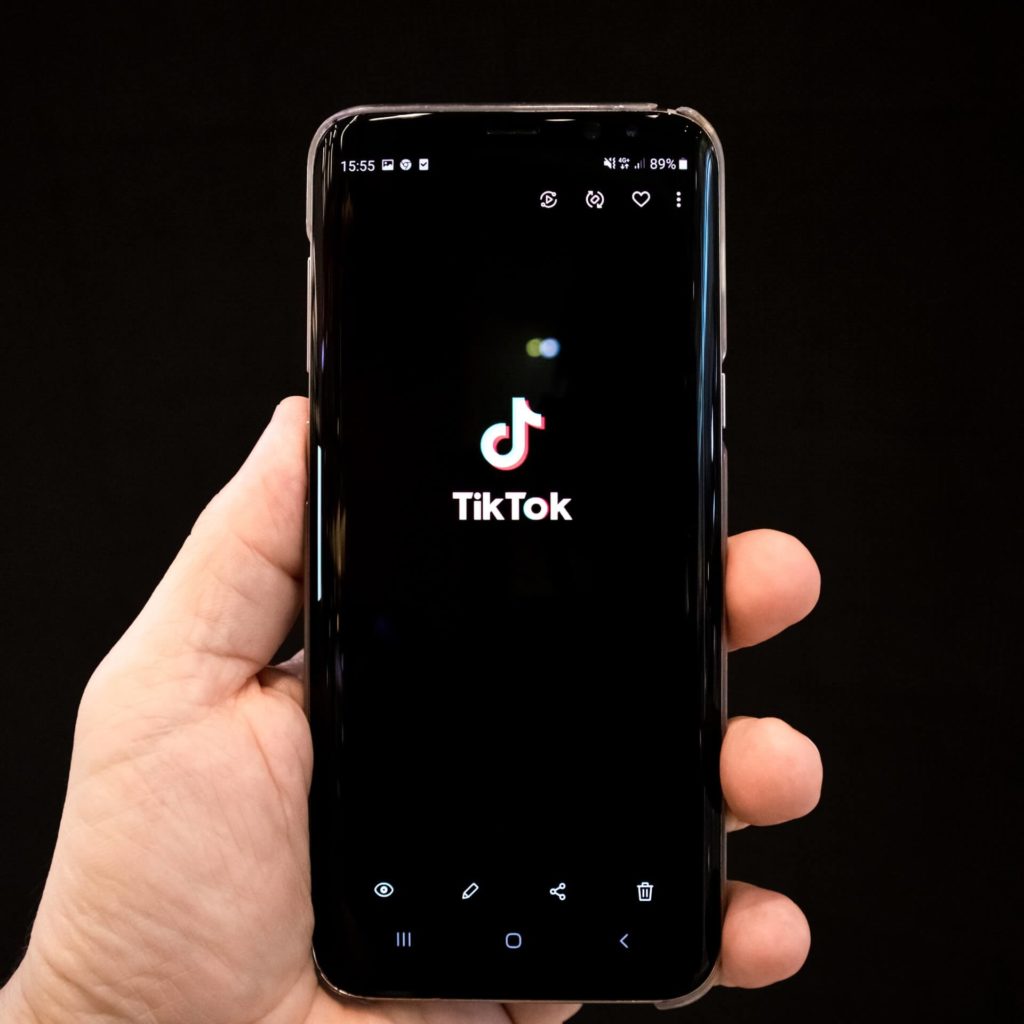 a phone showing the logo of TikTok app