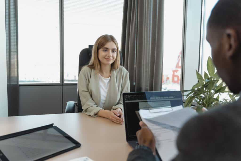 a man interviewing a woman in an office