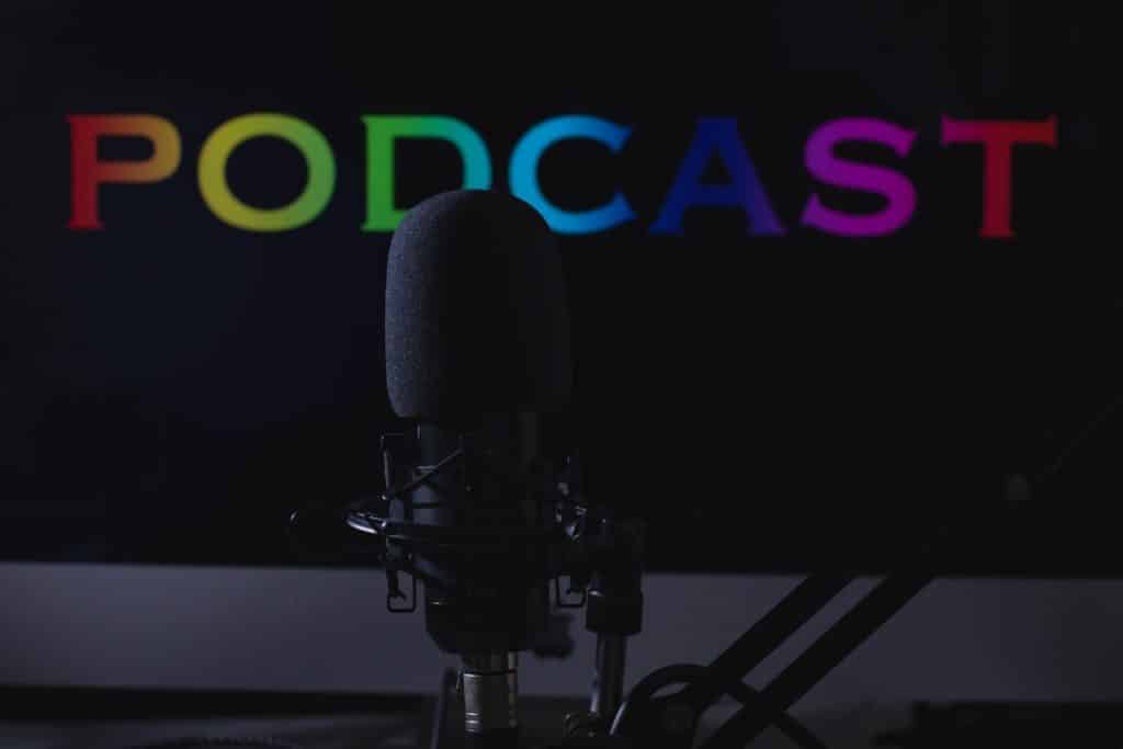Microphone in front of sign that says podcast