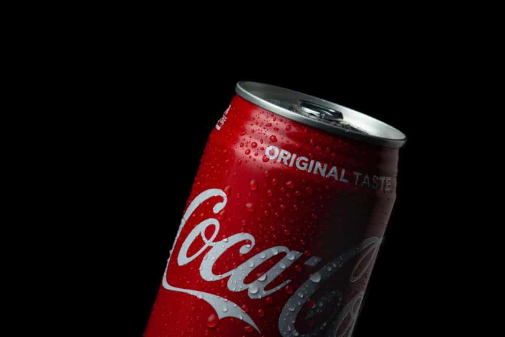 coca cola can on black background - content localization