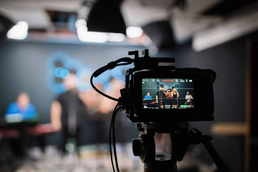 close-up of a camera capturing a video of 5 persons