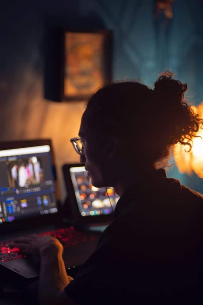 person working on his laptop in a dark room