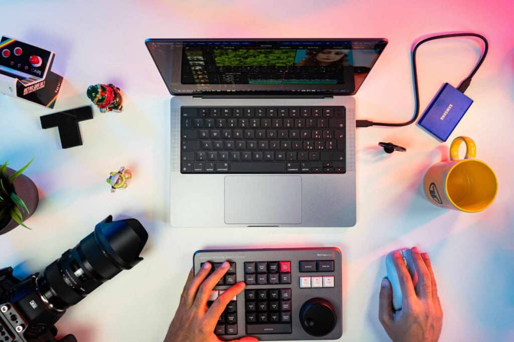 topview of a person working on a laptop with a camera and transcription device