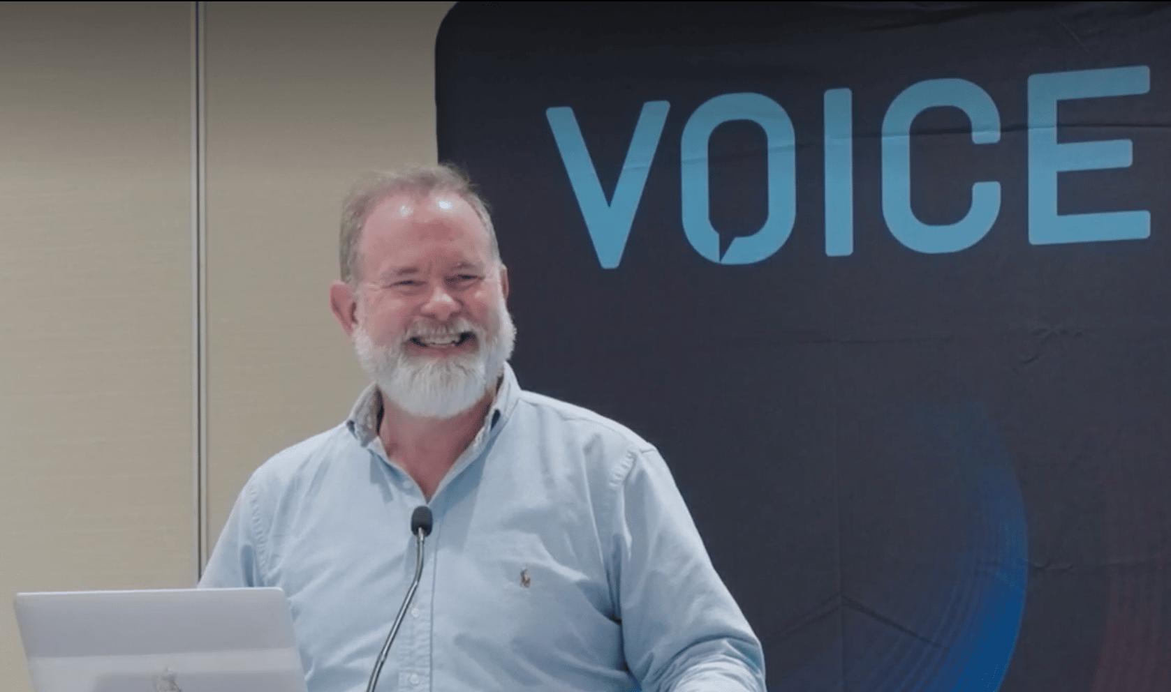 Verbit's Scott Ready speaking at a podium at the Voice22 conference