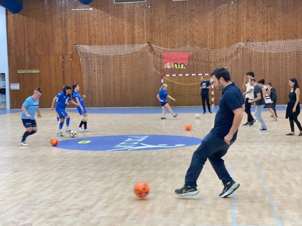 Verbit's CEO Tom Livne and and other participants learn futsal skills from the players