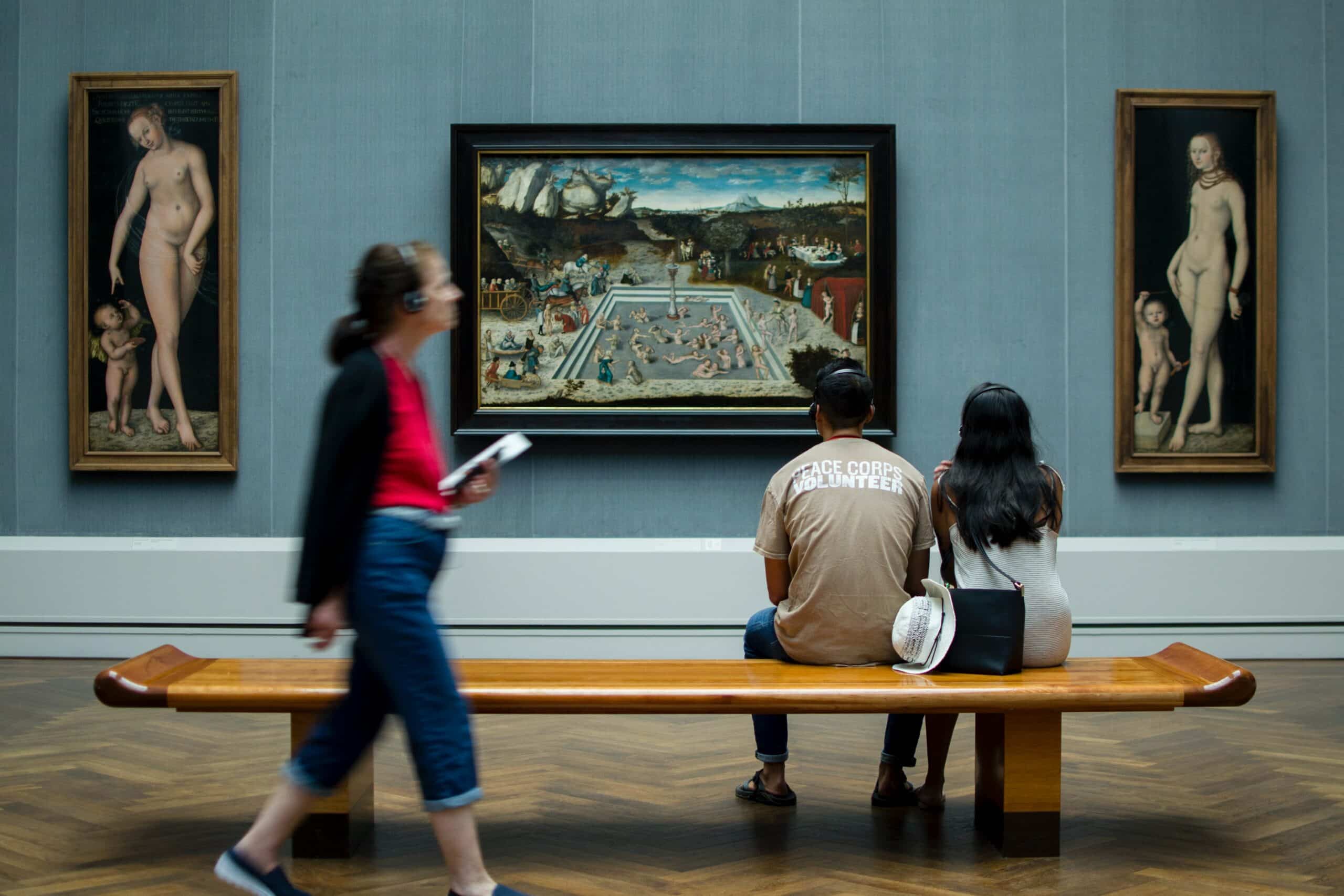 Museum visitors looking at a painting