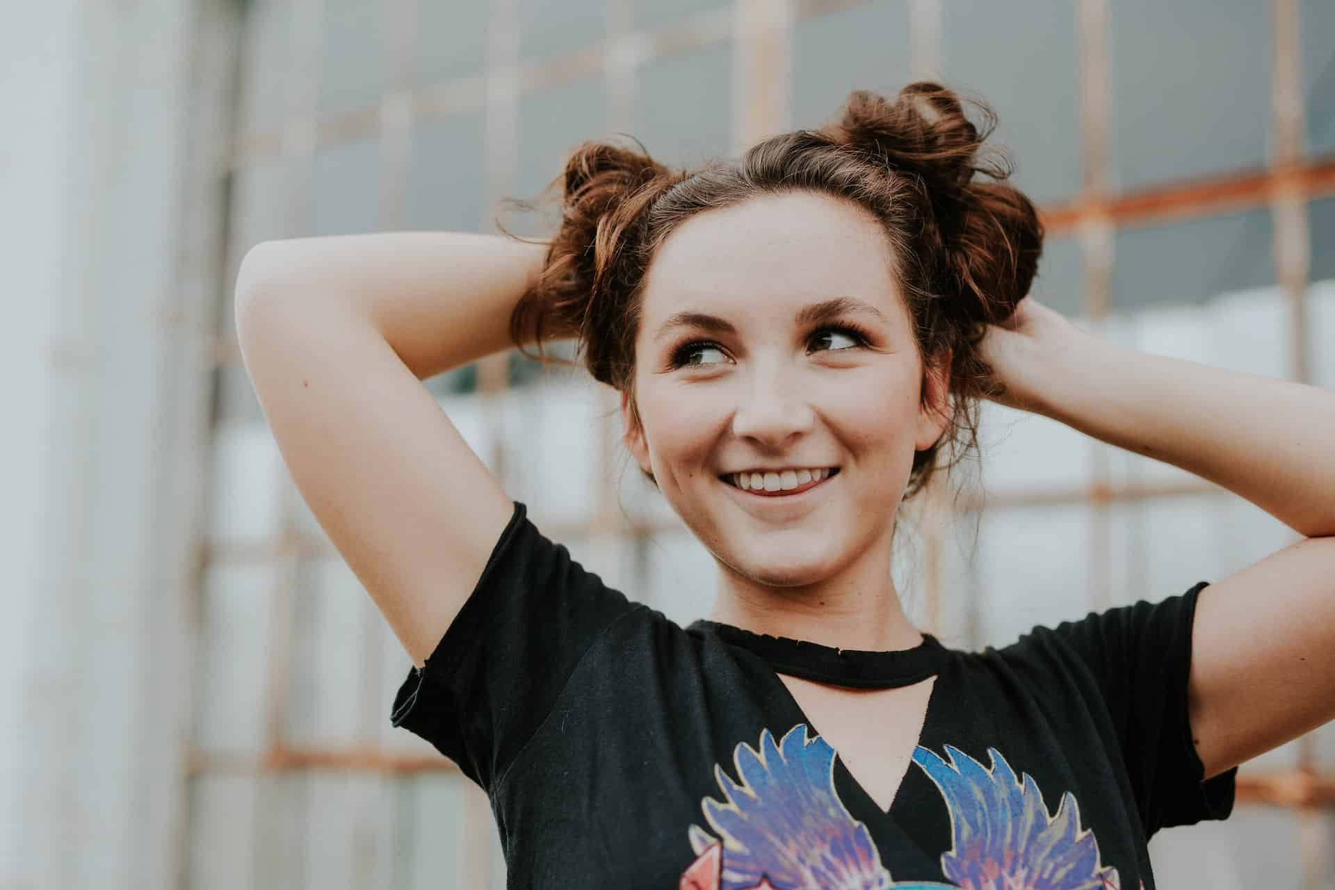 Young woman with her hair in two buns smiling