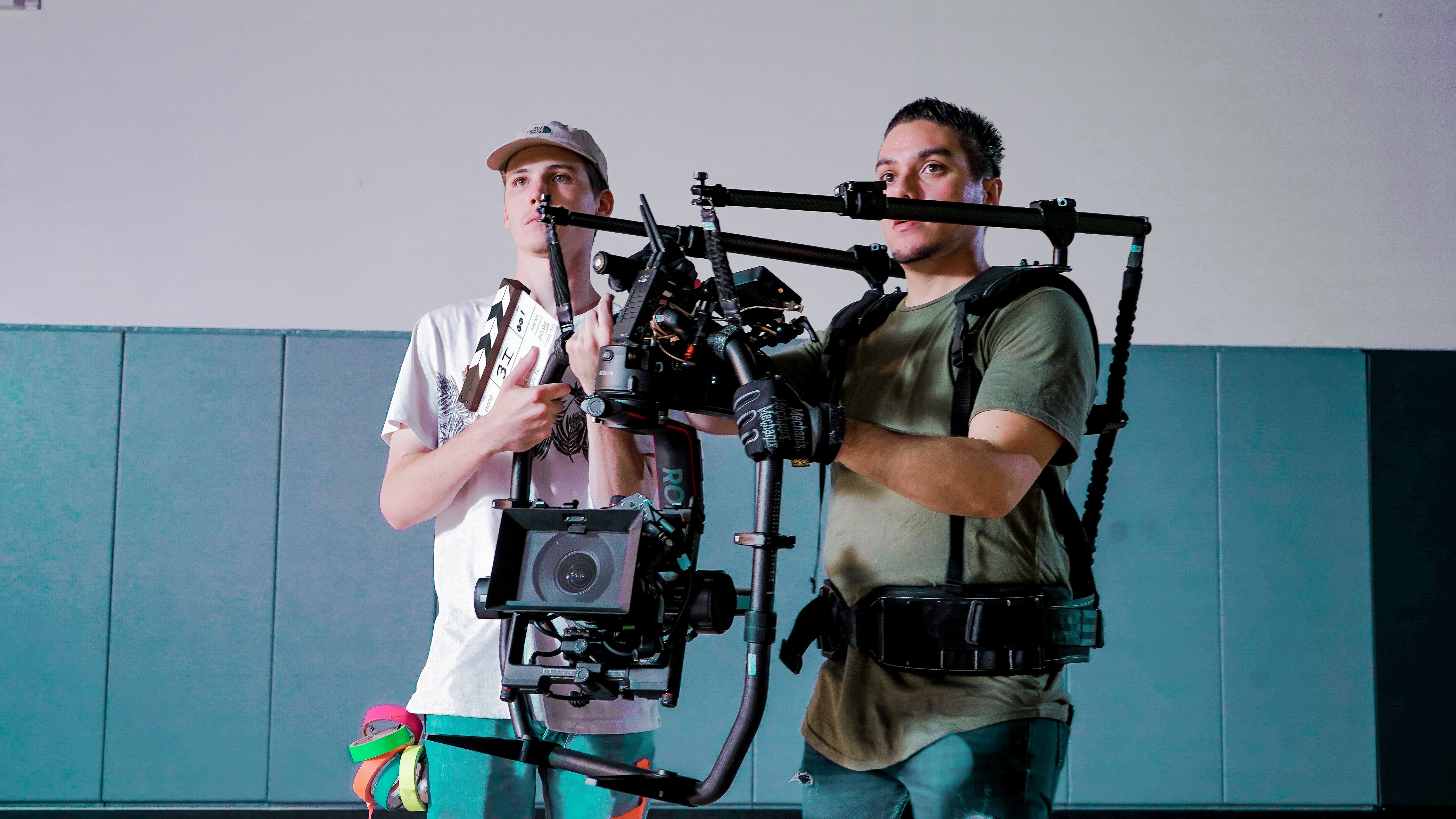 two people holding a camera setup