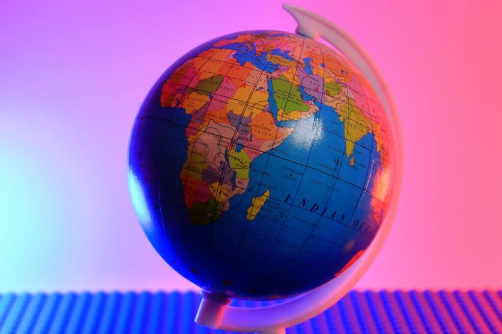 bright colored globe in front of a pink and purple backdrop