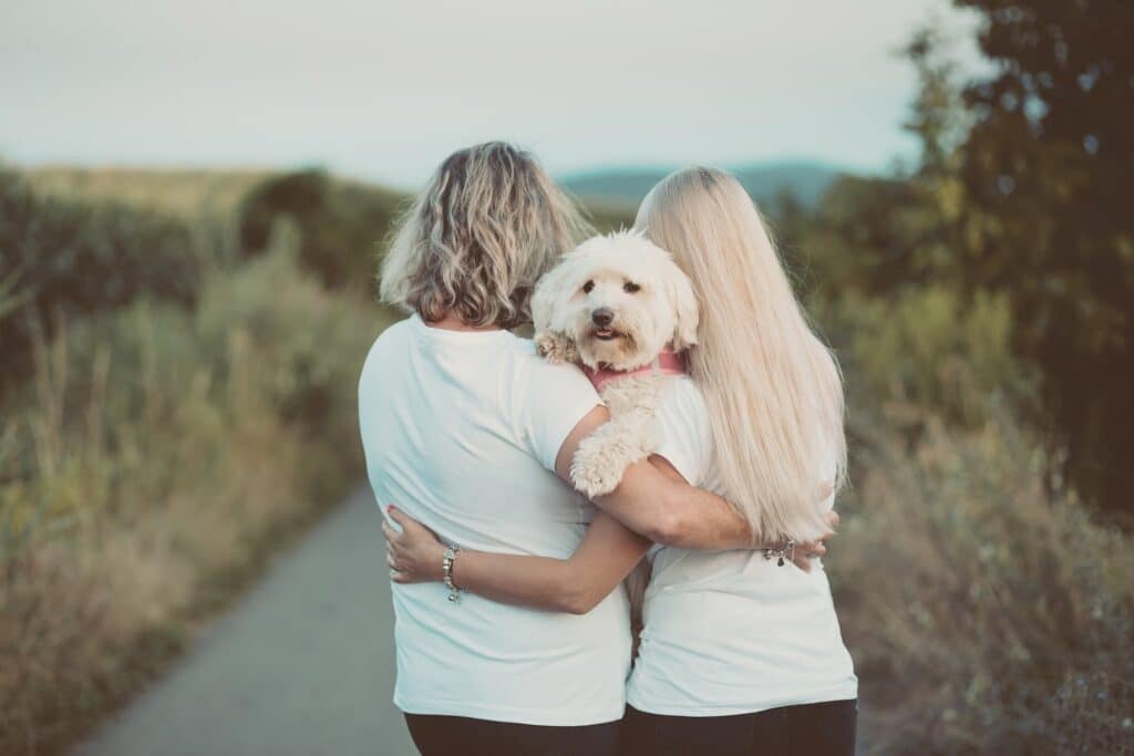 Mother and daughter holding a dog