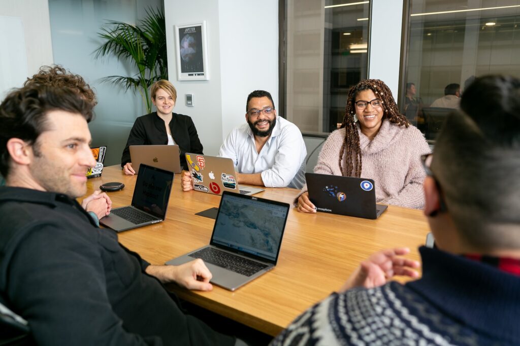People in a meeting smiling 