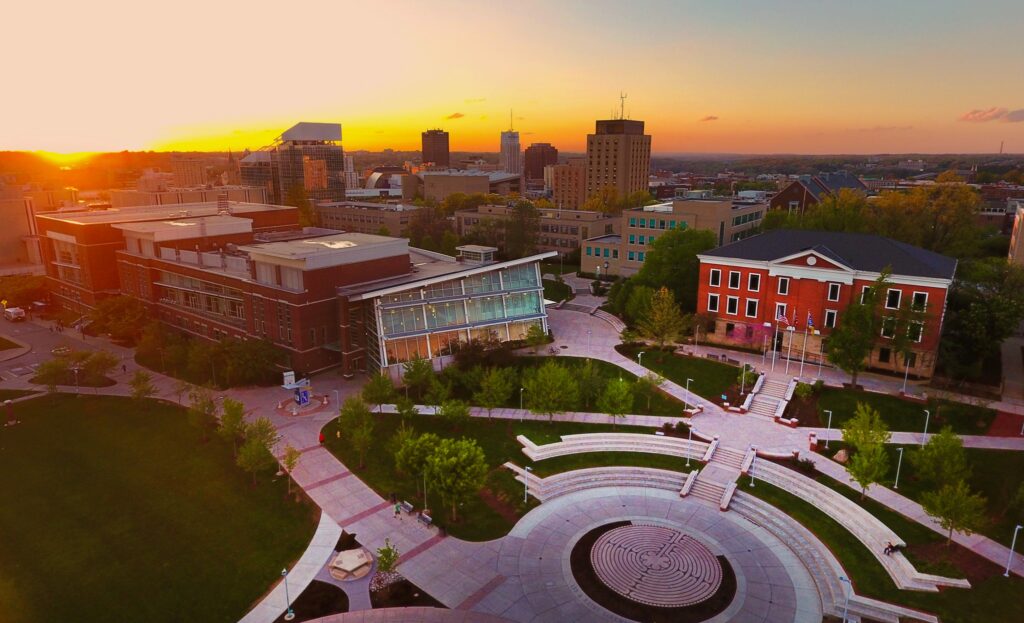 Aerial view of the University of Akron campus with sunset skyline and central plaza