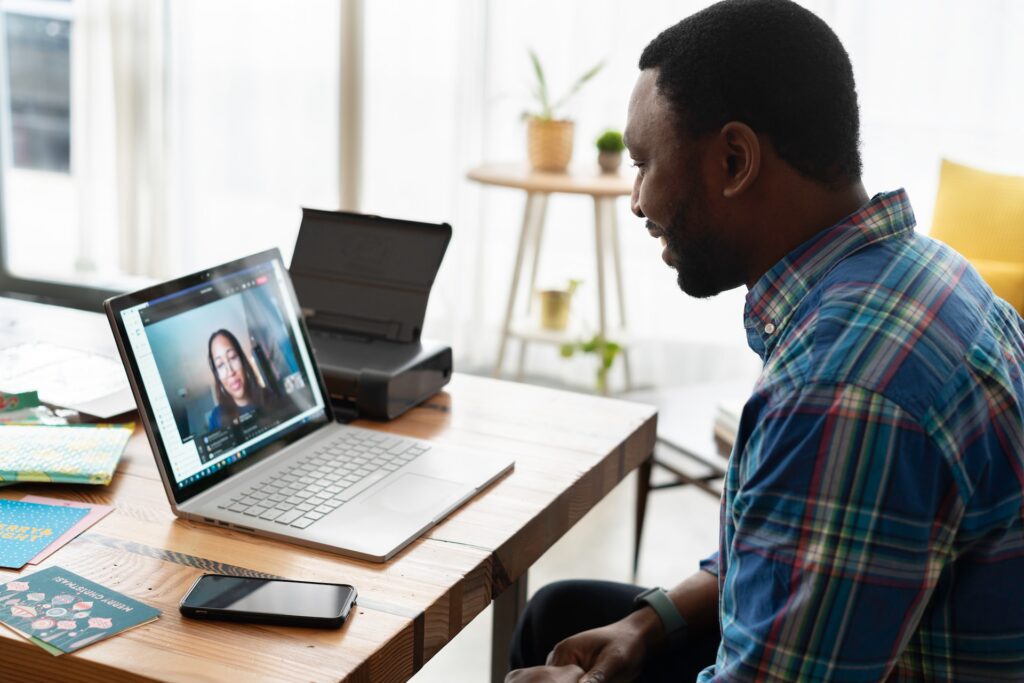 Man speaking to a woman on a video conference call