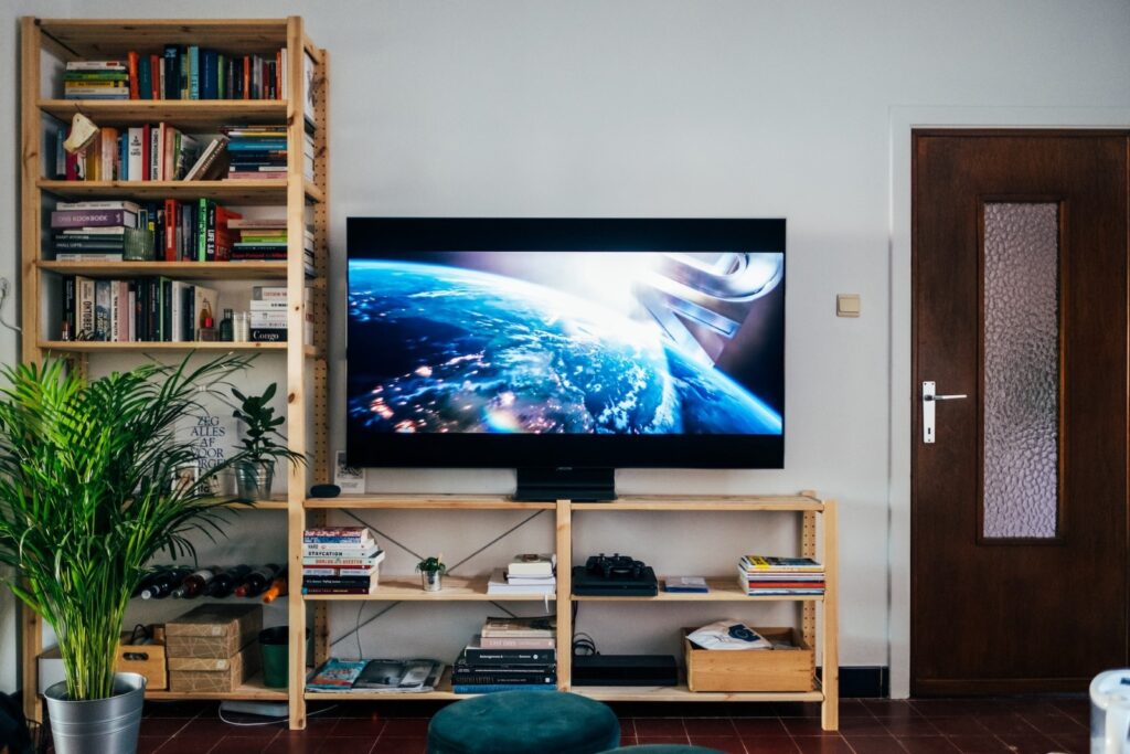 television on a tv rack with bookshelves