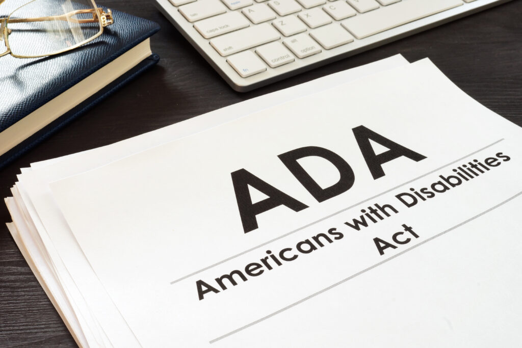 Paperwork on a desk that says "ADA Americans with Disabilities Act"
