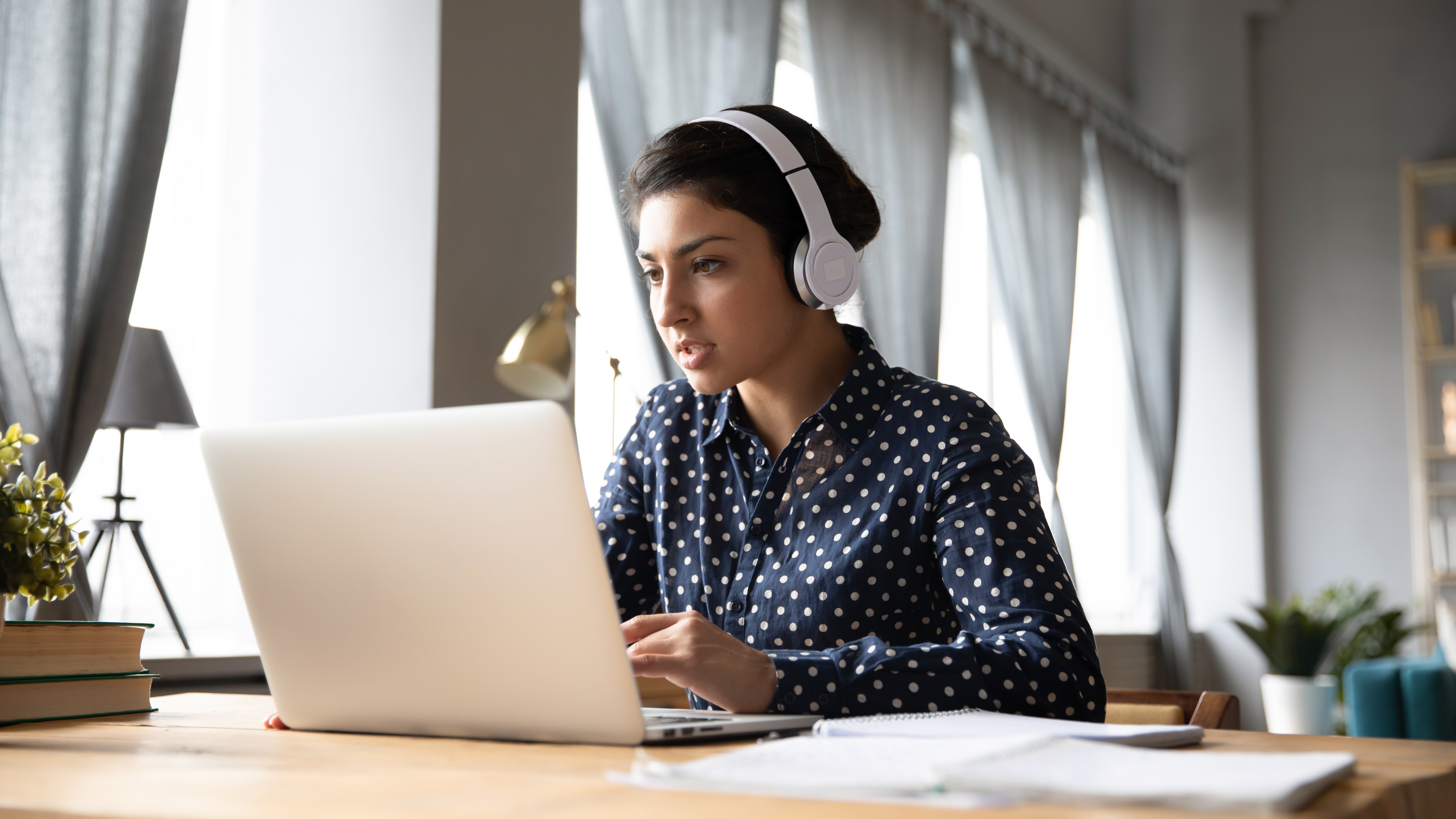 girl on computer wearing headphones