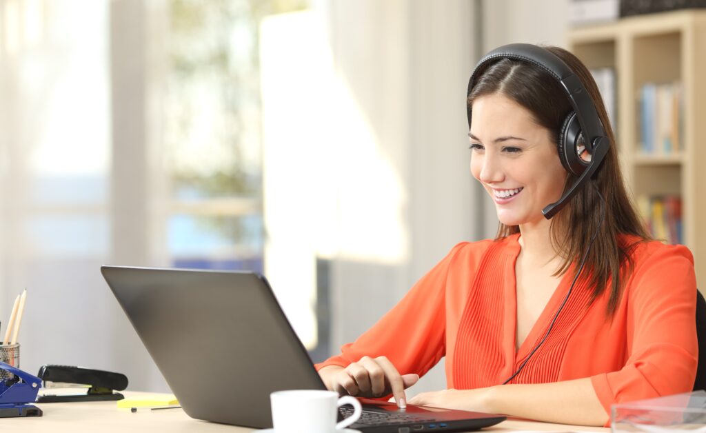 woman in a headset on a laptop computer