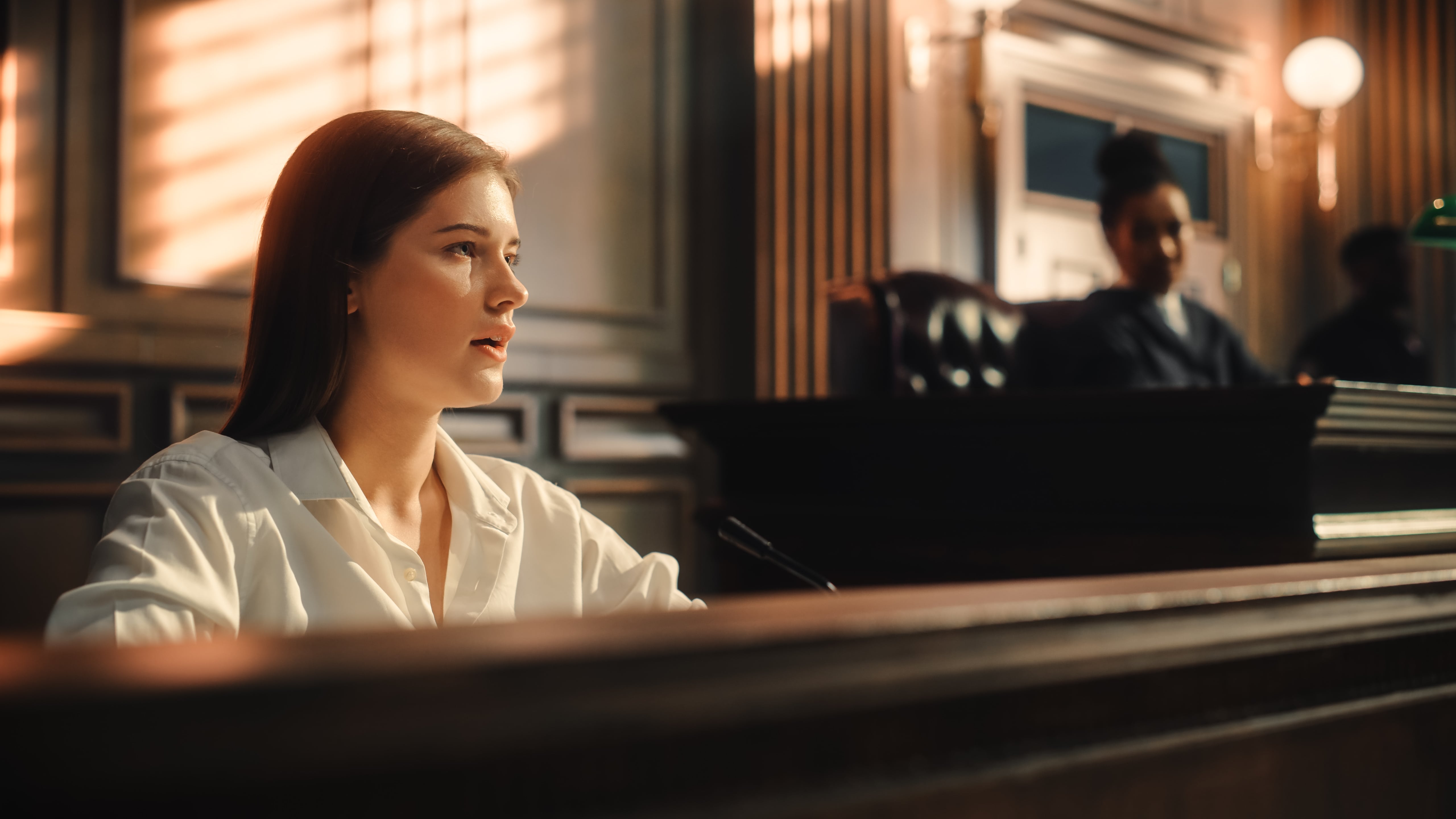 a woman testifying in a courtroom