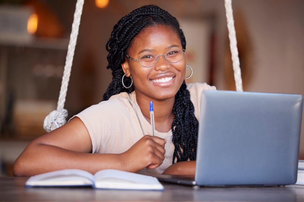Girl smiling and working on a computer