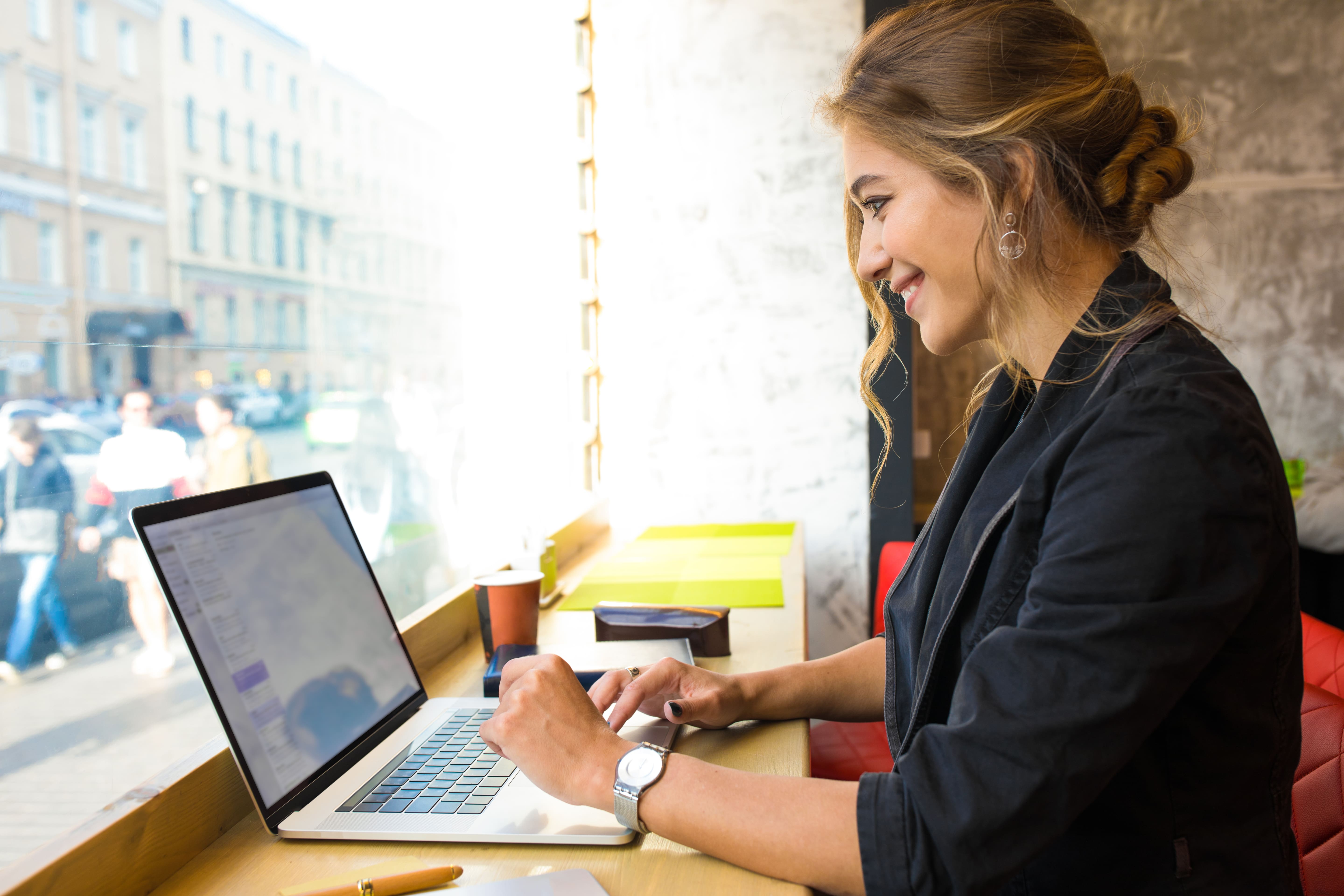 a professional woman happily working on a computer