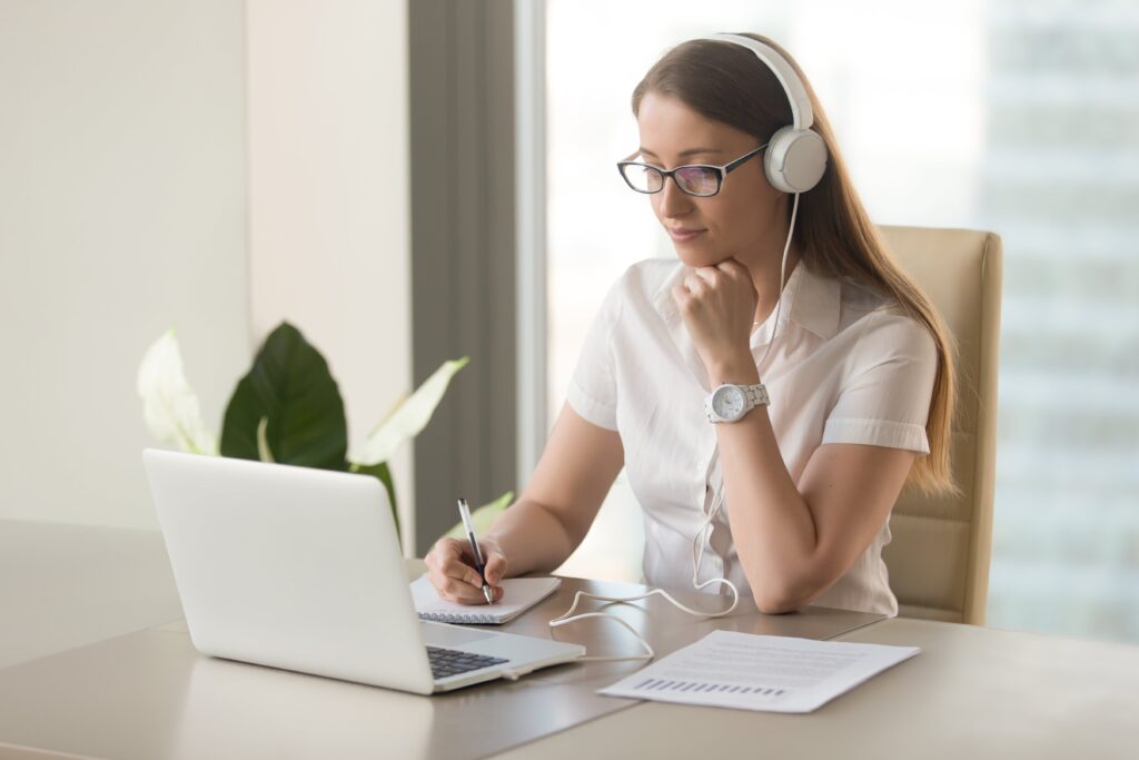 A young woman in headphones studying