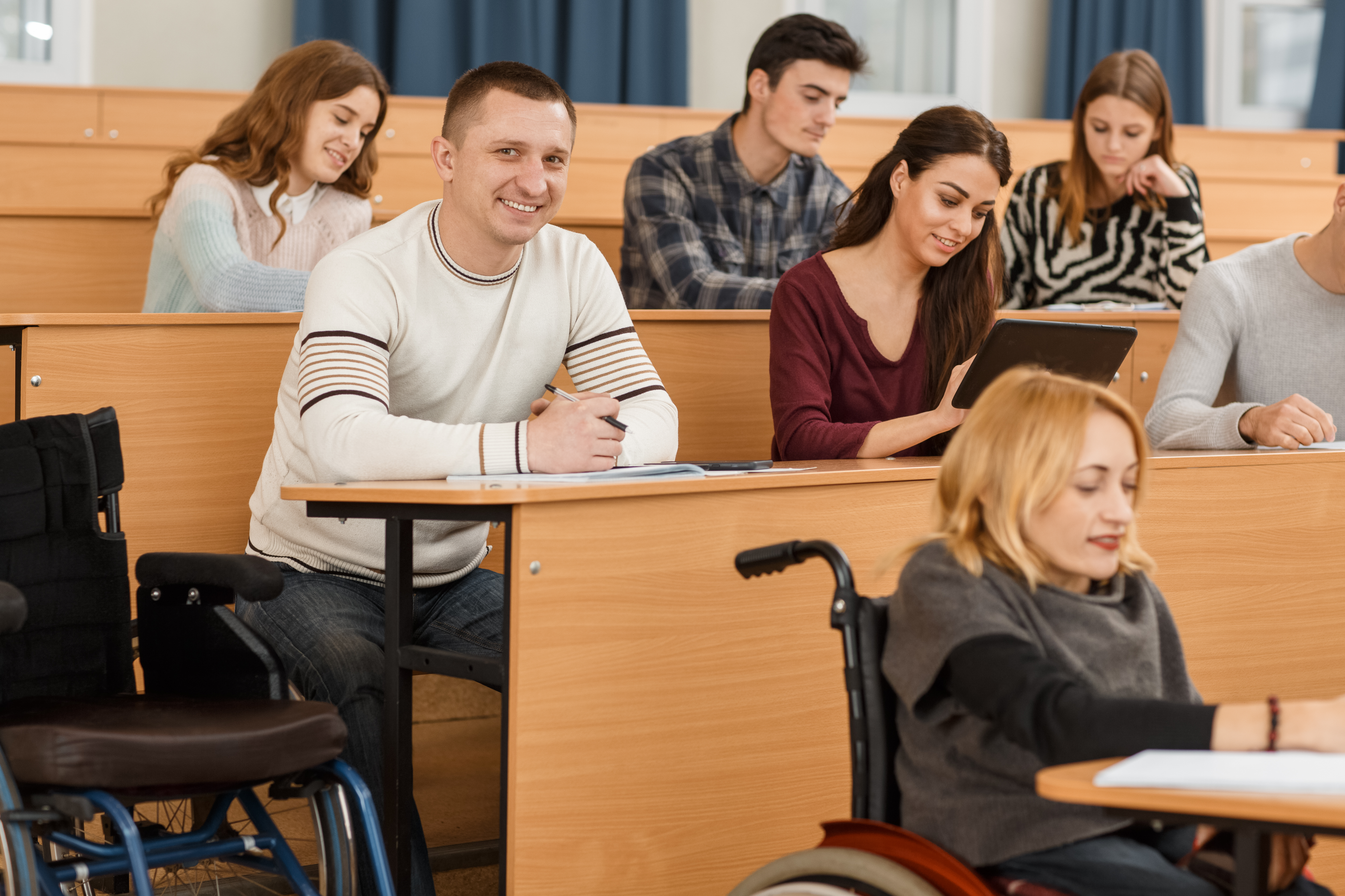 Cheerful,Adult,Student,Looking,At,Camera,,Smiling,And,Posing,While