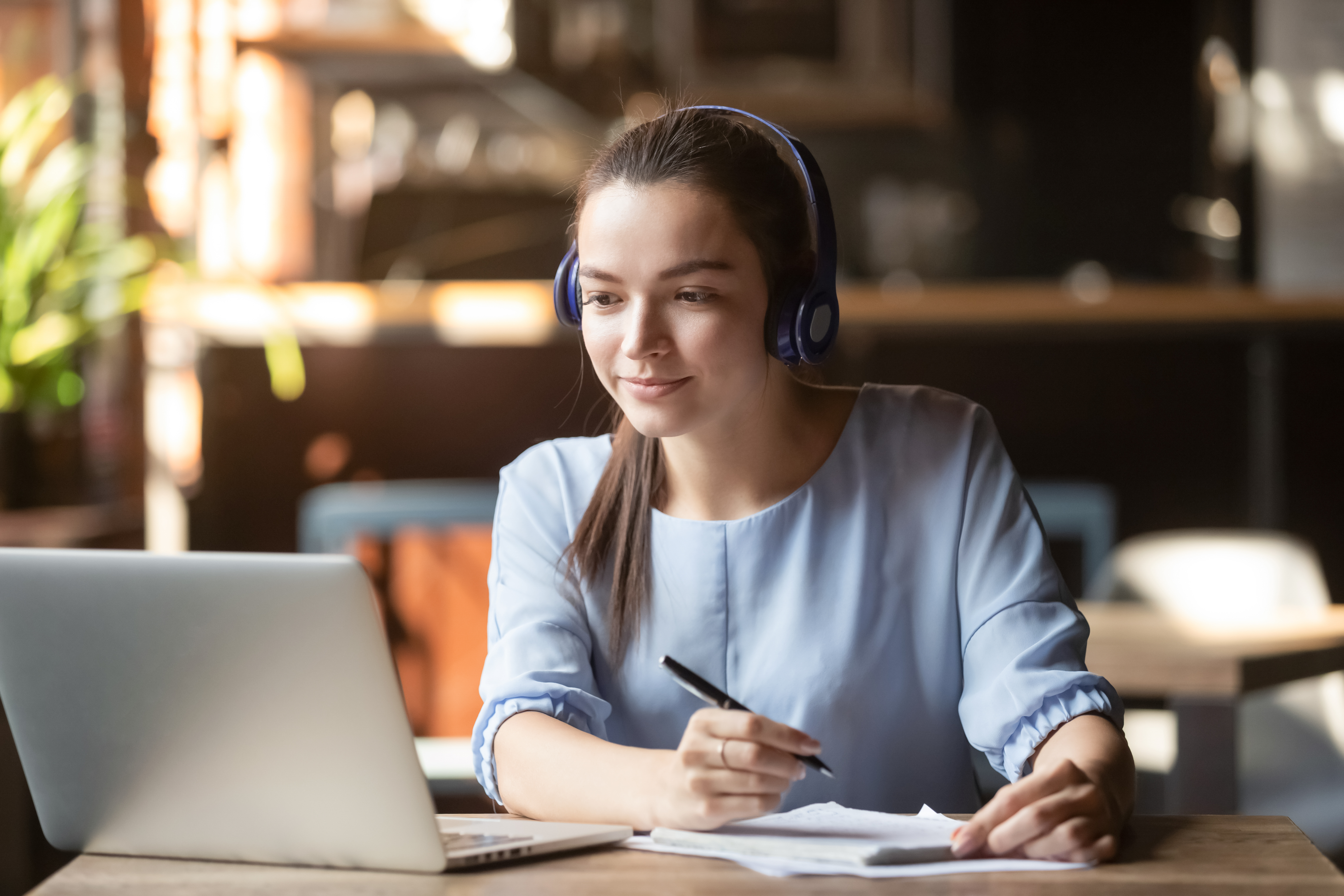 young female university student wearing headphones