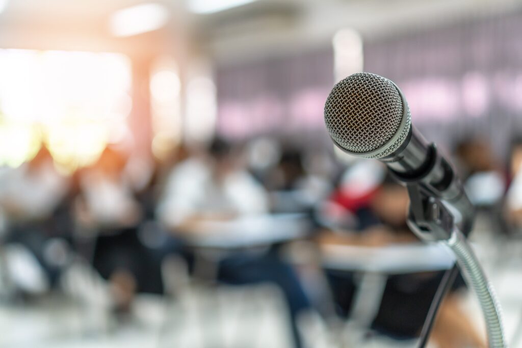 a microphone in front of a group of people at a meeting