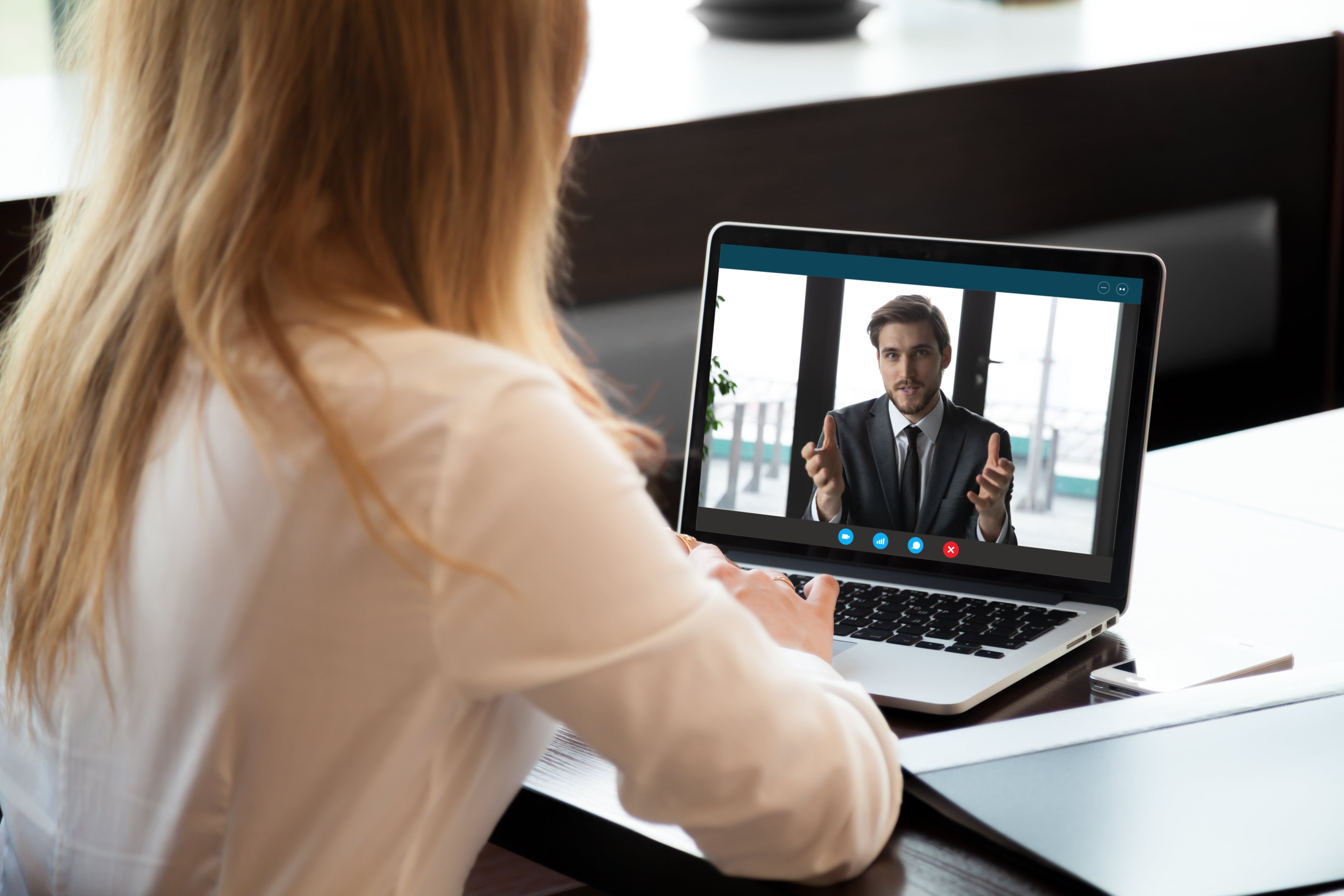 woman watching a speaker on her computer