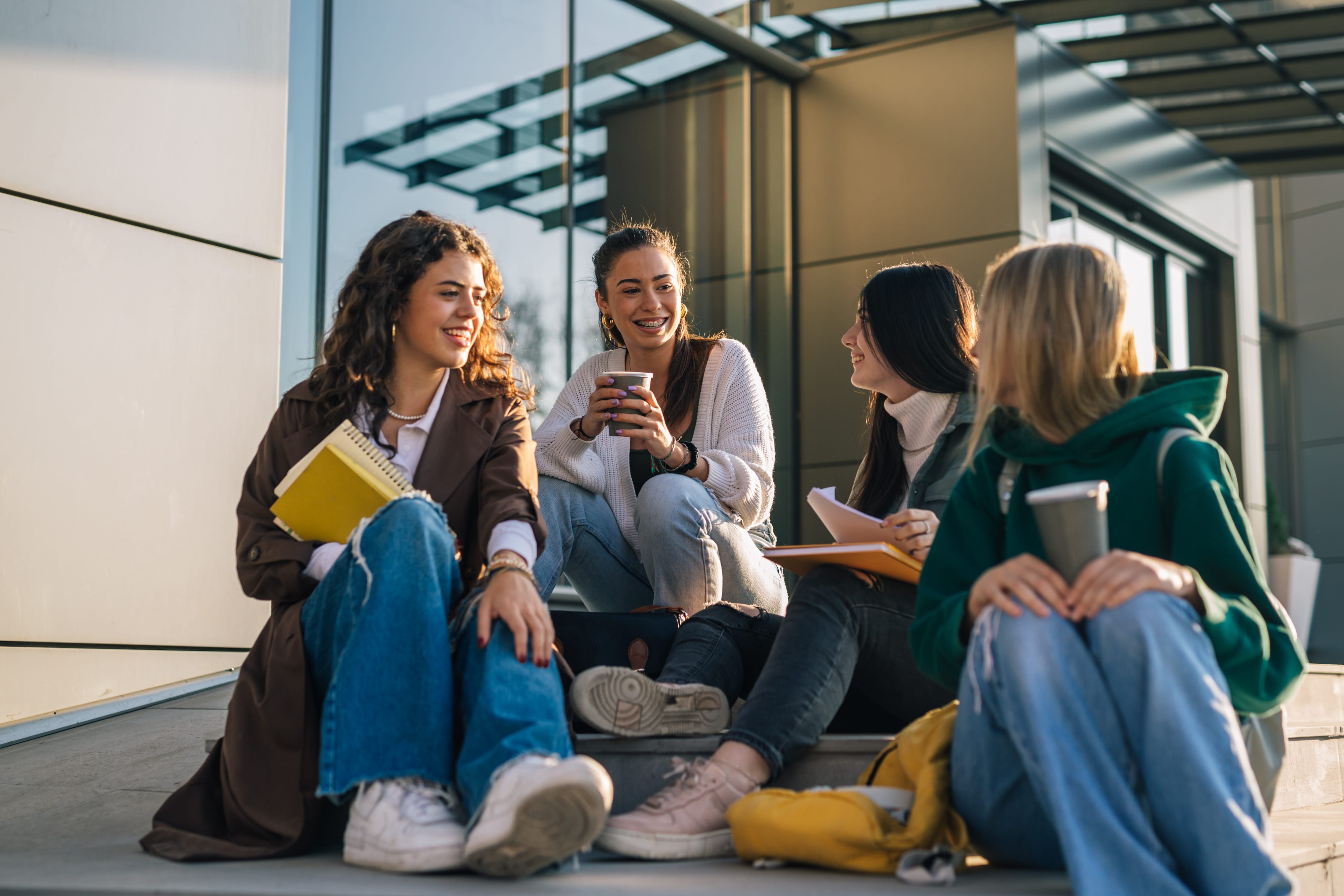 students sitting outside of a building