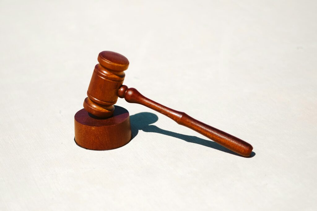Wooden judge's gavel on white background.
