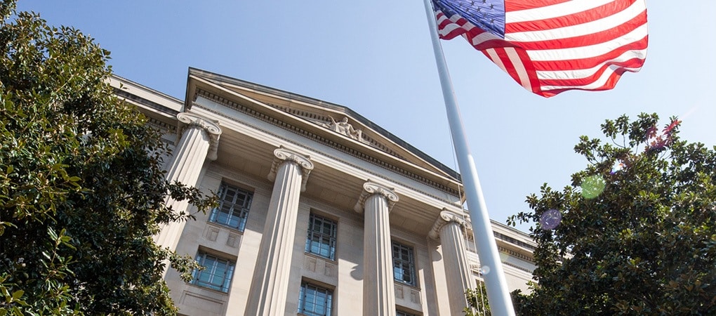 Exterior view of the US Department of Justice, showing the front of the building and four white marble columns