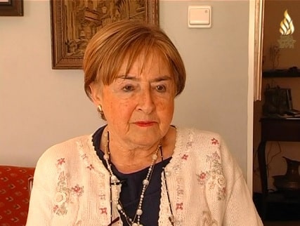 Gita Cycowicz, a woman, wearing a white sweater over a dark blue shirt.