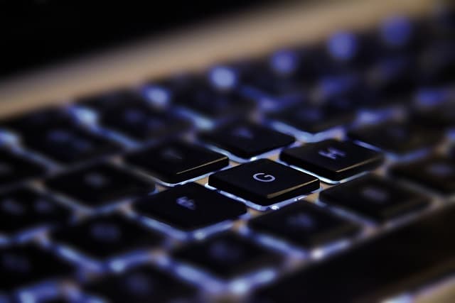 close up of a keyboard backlit with blue lights.