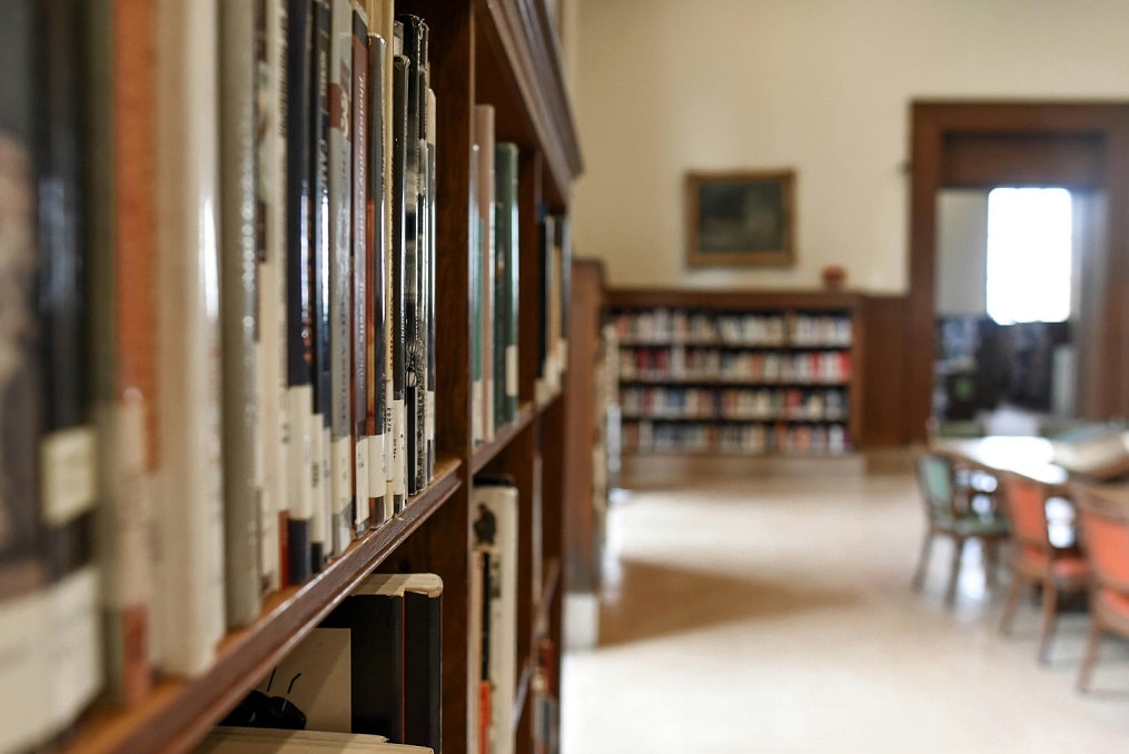 Books line a shelf in a library