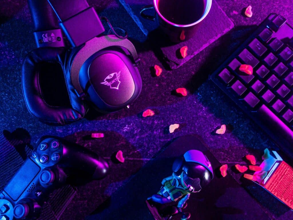 Gaming controllers and a computer keyboard can be seen in an overhead photo
