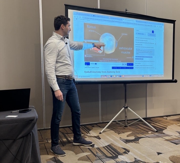 Verbit's Matthew Schwartz, a man with dark hair, points to information on a screen during a presentation