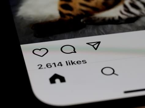 Phone screen showing 2,614 likes of a social media post.