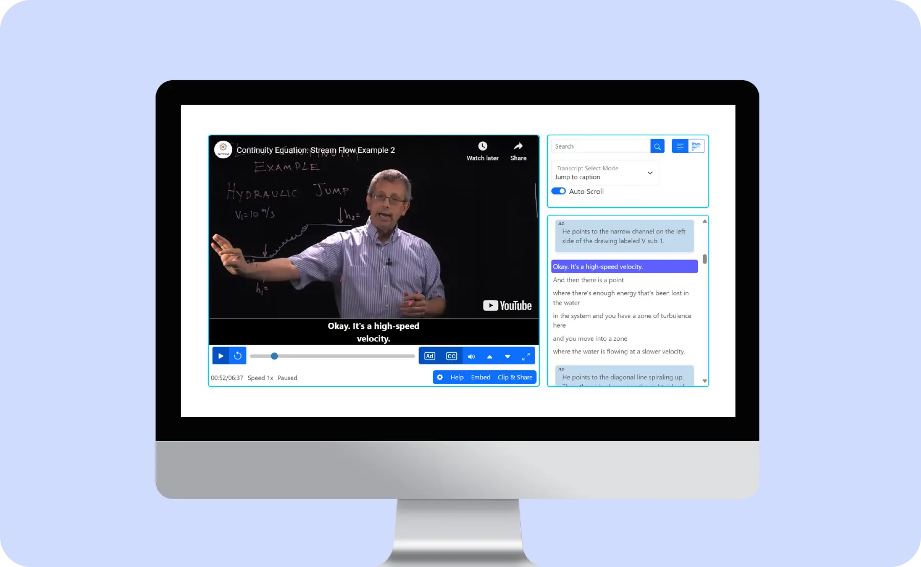 A video player is shown on a desktop with a video playing of a man lecturing wearing glasses with a transcript and audio description shown as part of the video player