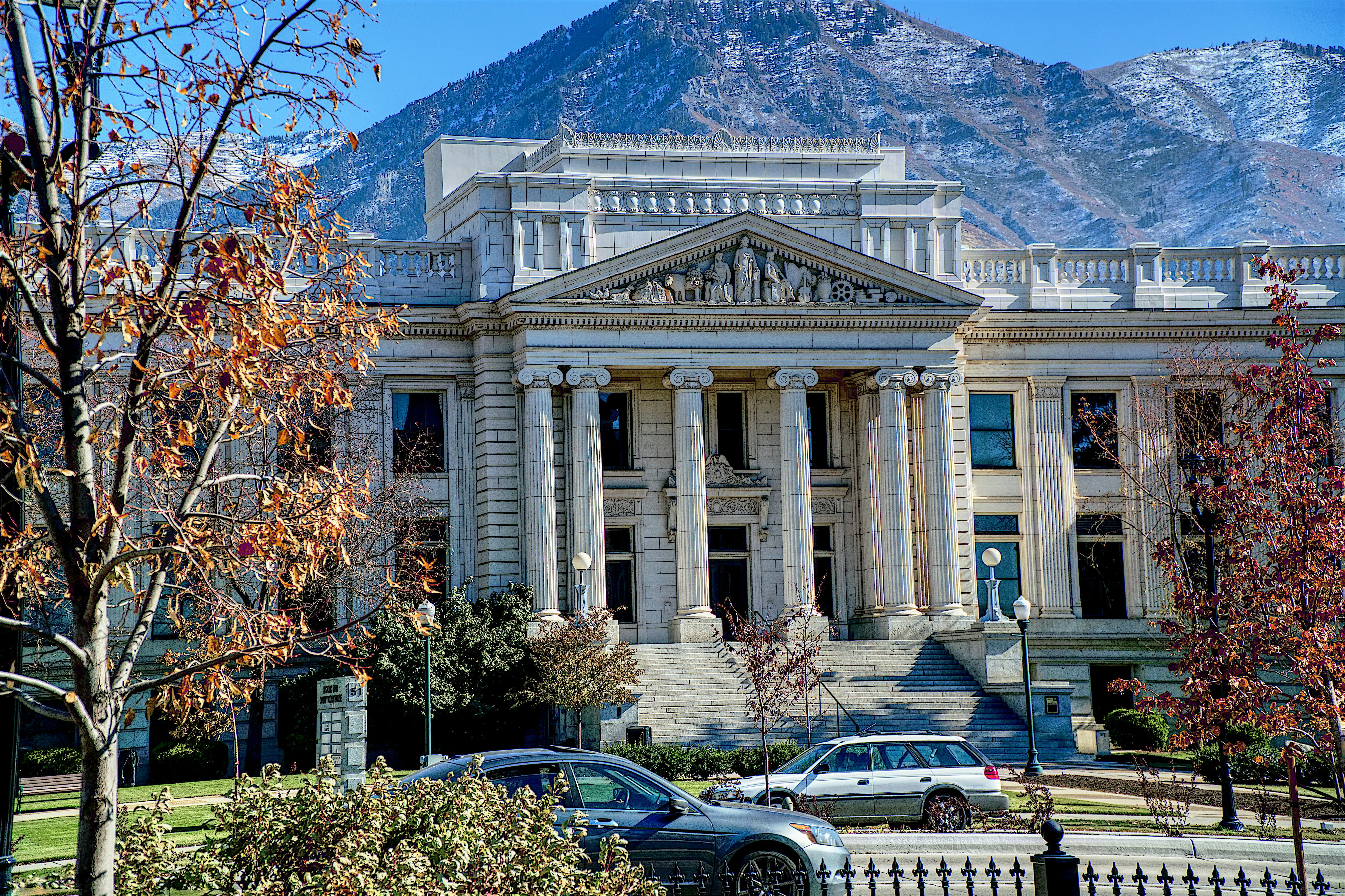 Utah County Courthouse shown in fall with scenic mountains in background