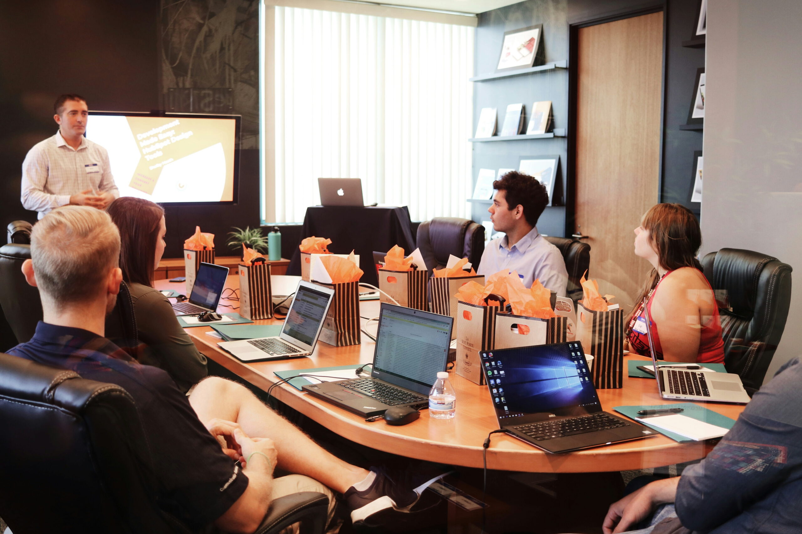 Professional team of attorneys and corporate strategists collaborating around a conference table during a business meeting.